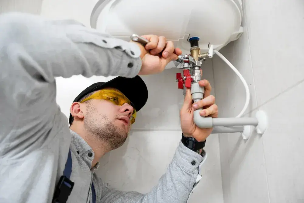 Plumber performing household plumbing and gas line related work