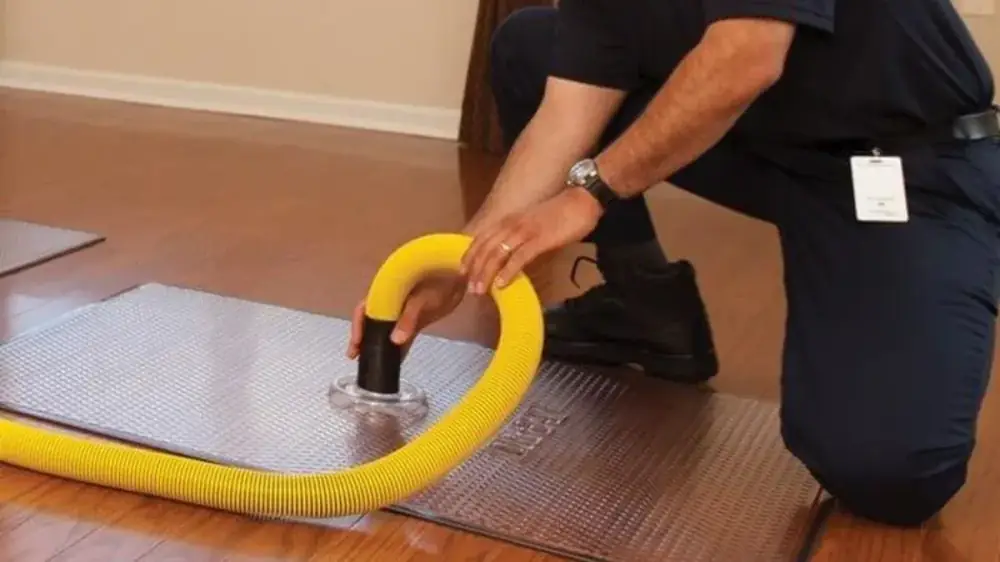 Plumber inspecting residential plumbing equipment in Richardson, TX